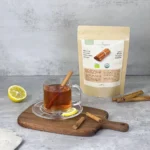 Cup of Ceylon cinnamon tea along with organic Ceylon cinnamon sticks package