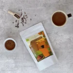 Cup of cacao along with cacao powder and cacao powder package